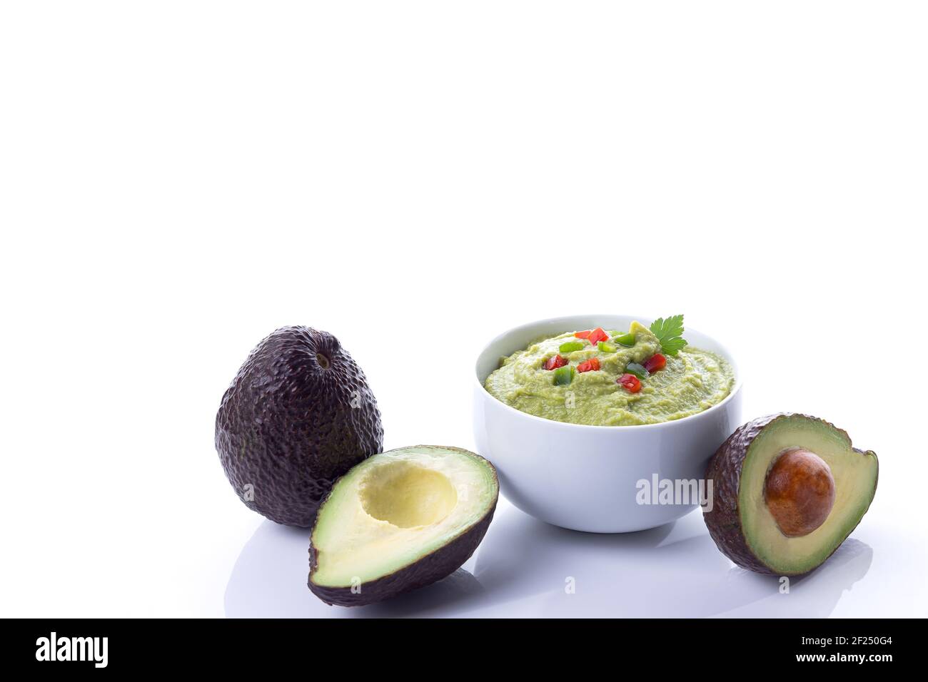 Guacamole bowl with avocados isolated on white background with copy space. Stock Photo