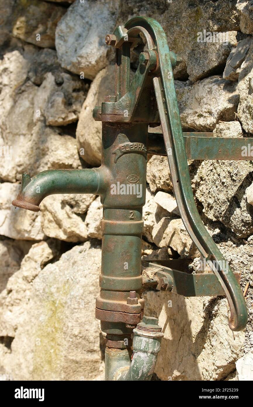 The old rusty manual pump with the lever for water swapping Stock Photo -  Alamy