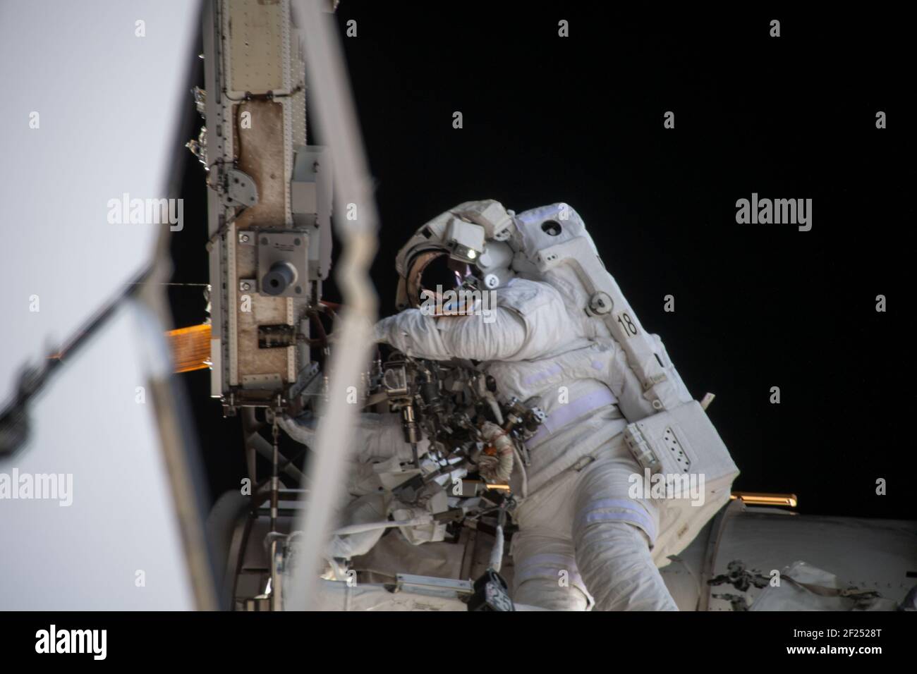Japan Aerospace Exploration Agency astronaut Soichi Noguchi during a spacewalk to install solar array modification kits on the International Space Station March 5, 2021 in Earth Orbit. The maintenance work will support new, more powerful solar arrays that will be delivered on upcoming SpaceX Dragon cargo missions. Stock Photo