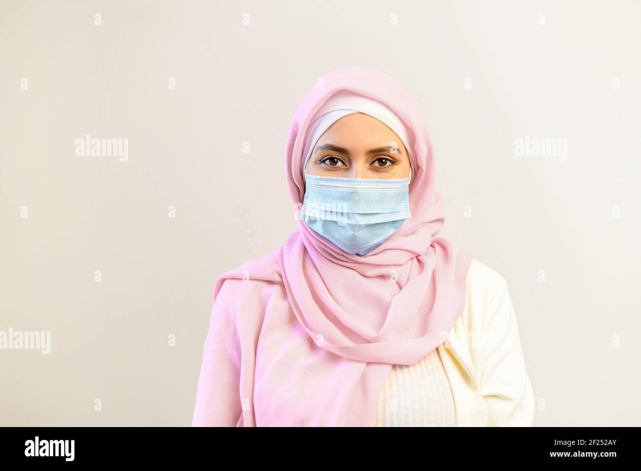Download Young Muslim Arab Female Doctor Healthcare Worker Or Patient In Hijab And Protective Face Mask Standing
