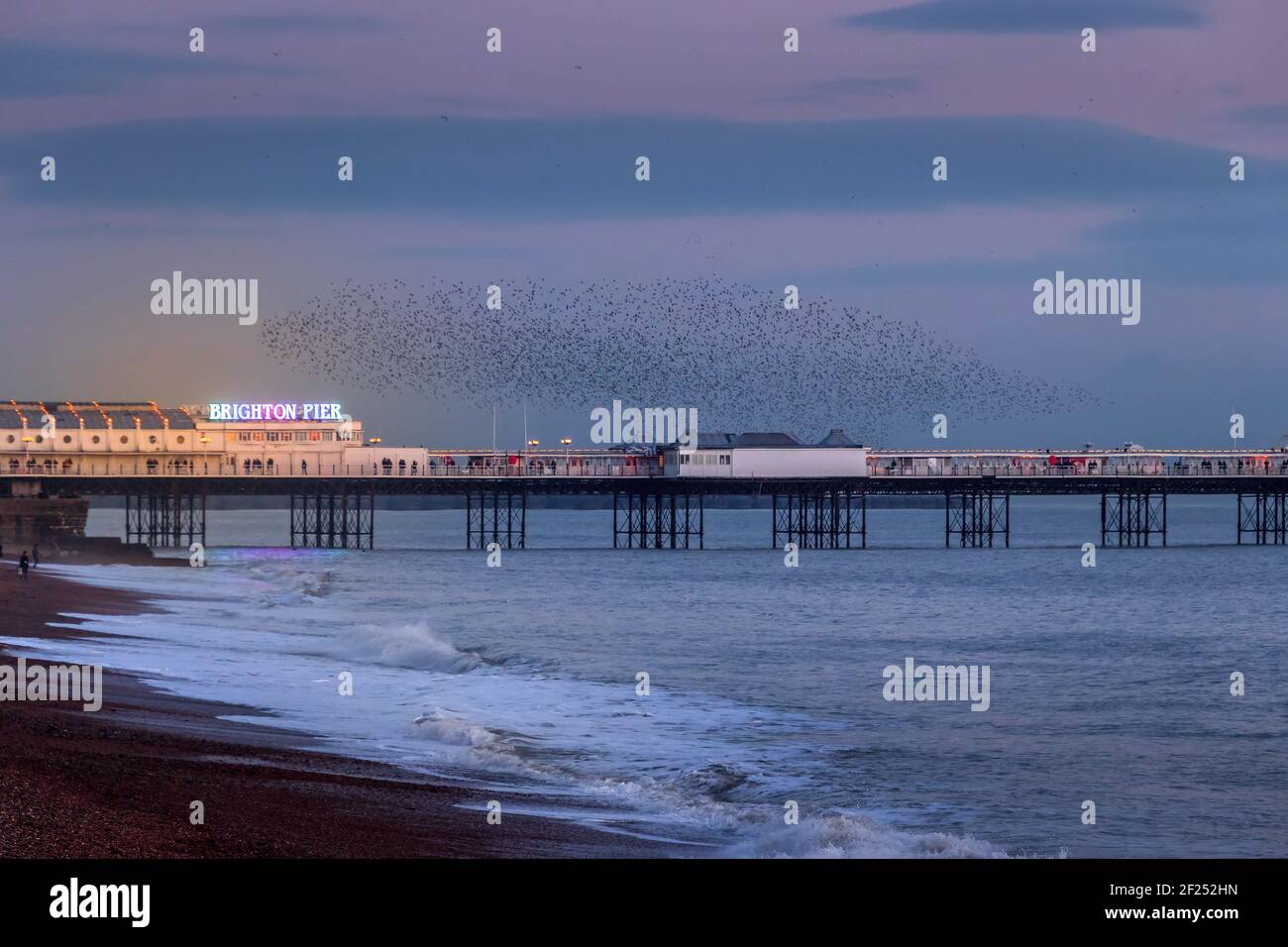 BRIGHTON, EAST SUSSEX/UK - JANUARY 26 : Starlings over the Pier in Brighton East Sussex on January 26, 2018. Unidentified people Stock Photo