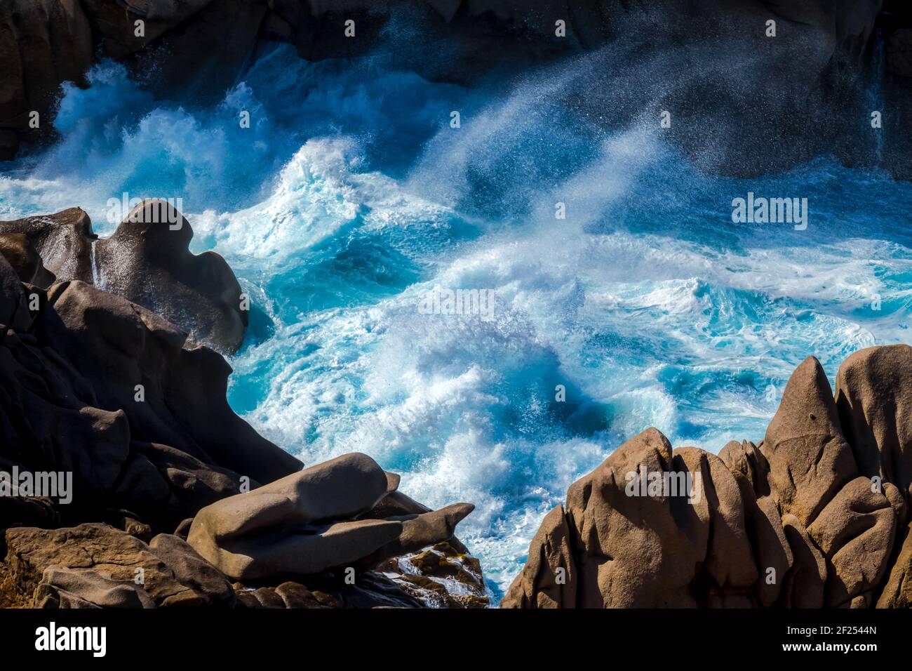 Waves Pounding the Coastline at Capo Testa Stock Photo