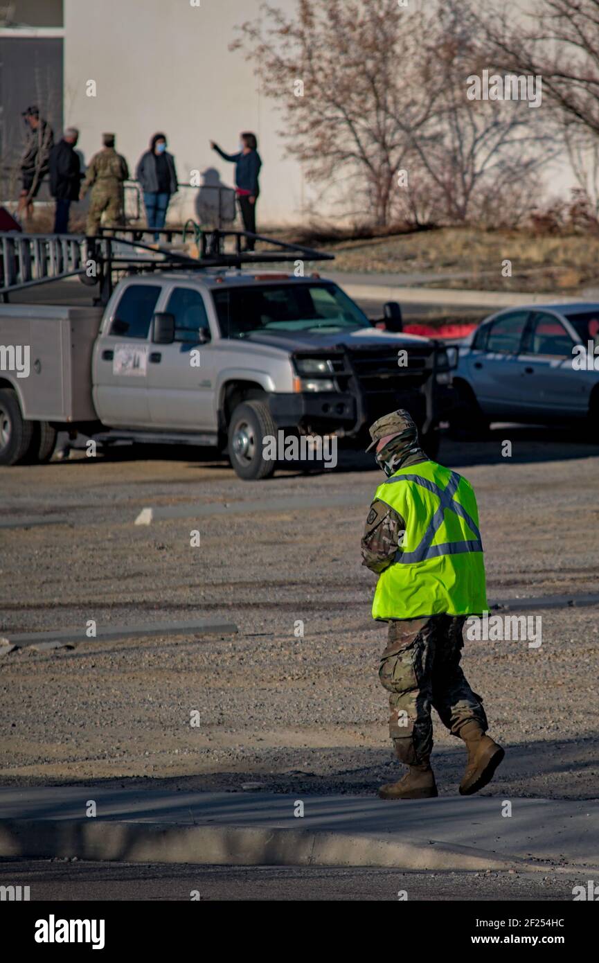 Farmington, New Mexico USA-March 10th 2021: Police Army National Guard directing covid 19 corona virus vaccine recipients to parking and pre screening Stock Photo