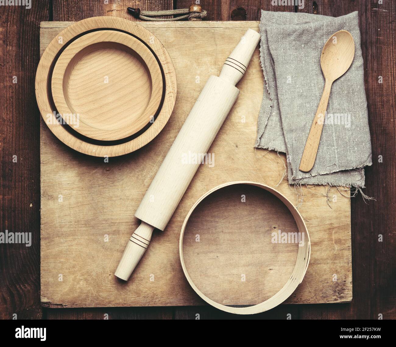 Wooden kitchen vintage items sieve, rolling pin, empty spoons and