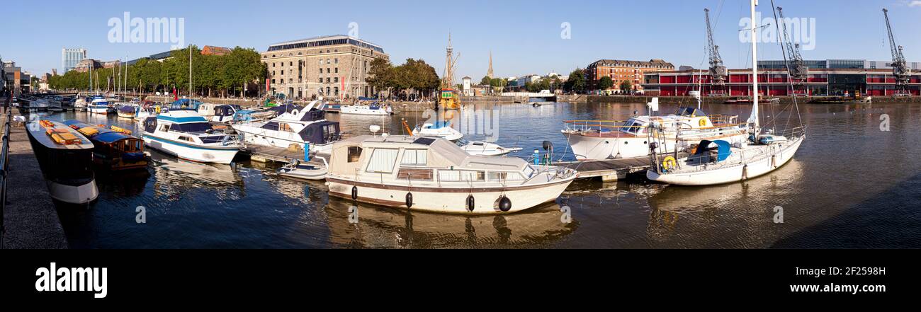 A panoramic view of evening light on the harbourside at Bristol Docks, UK - The Arnolfini Gallery and St Marys Redcliffe church are across the water. Stock Photo