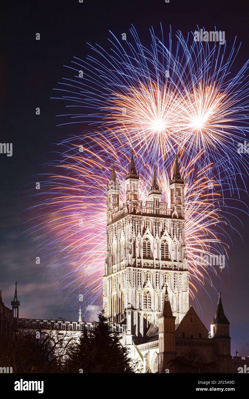 Fireworks bursting behind the tower of Gloucester Cathedral UK on Guy Fawkes Night 5th November. Stock Photo