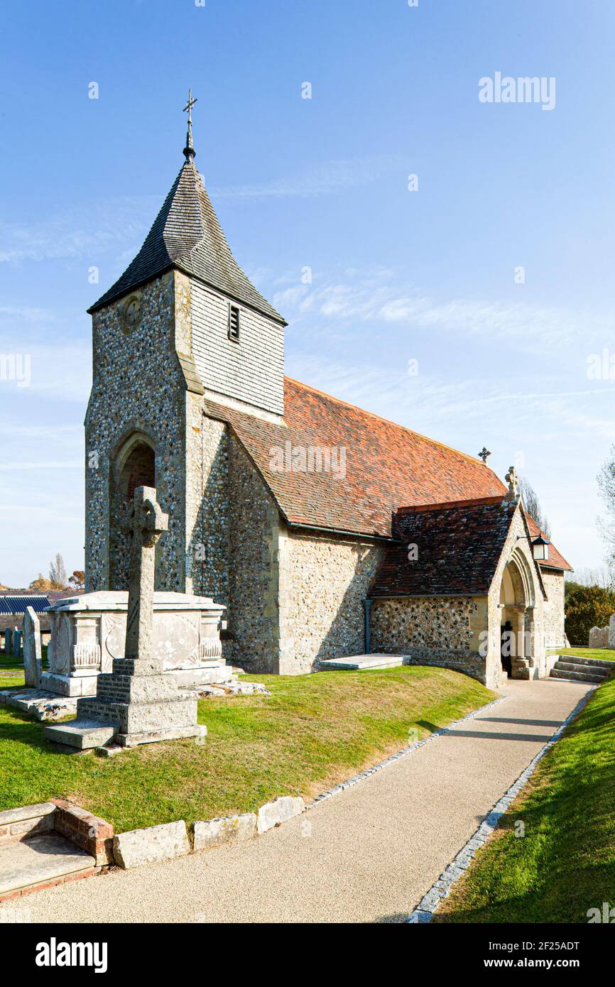 St Nicholas church, West Itchenor, West Sussex UK - built of traditional local flint rubble with the broach spire covered with shingles Stock Photo