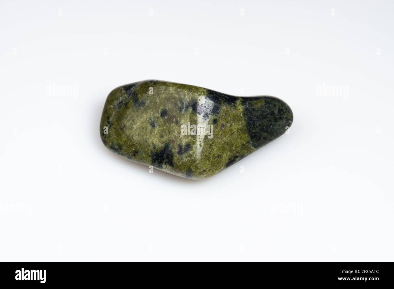 Natural stone green serpentine on a white background Stock Photo - Alamy