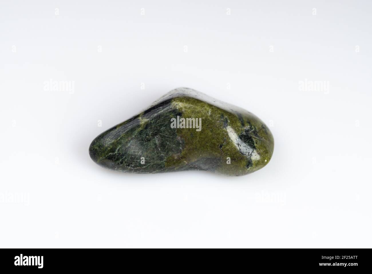 Natural stone green serpentine on a white background Stock Photo - Alamy