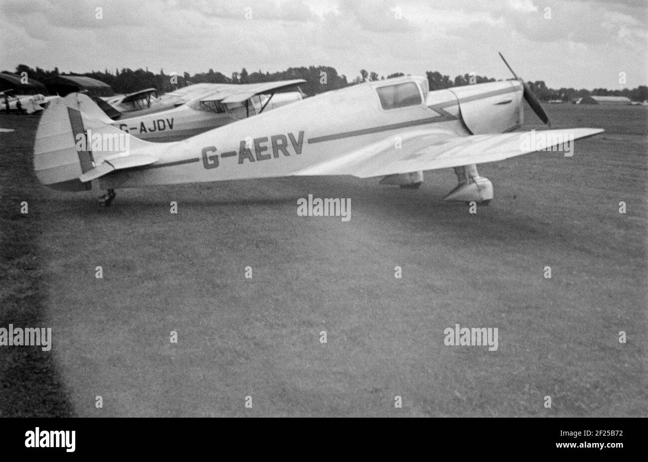 A vintage 1958 black and white photograph of a Miles M.11A Whitney Straight light aircraft, registration G-AERV, taken at an airfield in England. Stock Photo