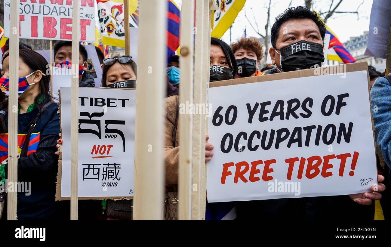 Thousands of Tibetans and supporters protest on the streets of Trocadero square near the famous Eiffel Tower in Paris to commemorate the 62th anniversary of the Tibetan National Uprising Day. A street play was organised on the recent death of Tenzin Nyima, a 19 year old Tibetan monk due to torture in Chinese prison. Stock Photo