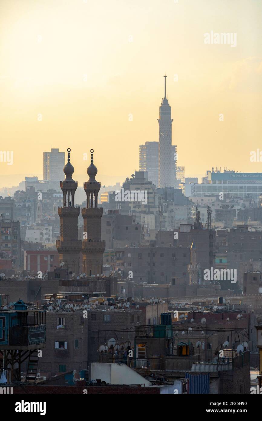 Atmospheric Cairo cityscape at sunset showing Cairo Tower and minarets, as seen from Al Azhar Park, Salah Salem St, El-Darb El-Ahmar, Cairo, Egypt Stock Photo