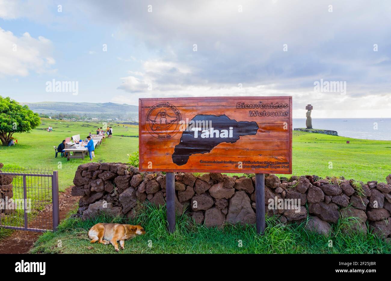 Name sign at Tahai ceremonial complex, Hanga Roa, west coast of Easter Island (Rapa Nui), Chile with Ahu Ko Te Riku moai statue in the background Stock Photo
