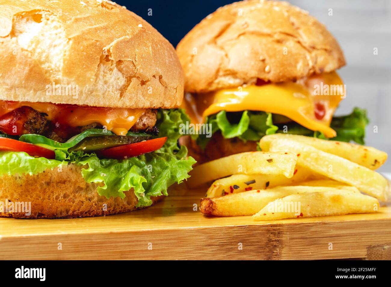 side view burgers chicken patty with cheese tomato pickled cucumber and