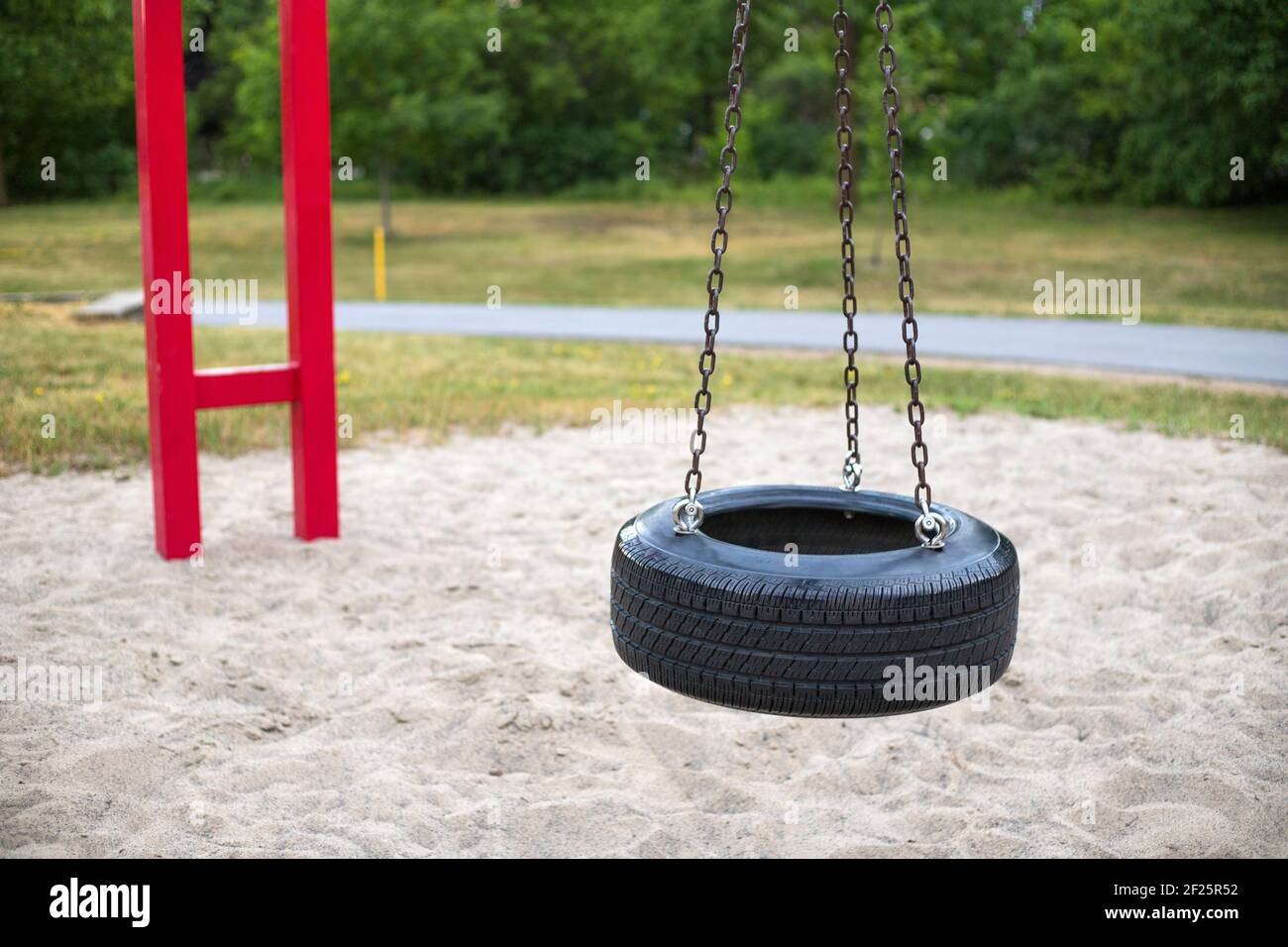 tire swing on playground in the park Stock Photo Alamy