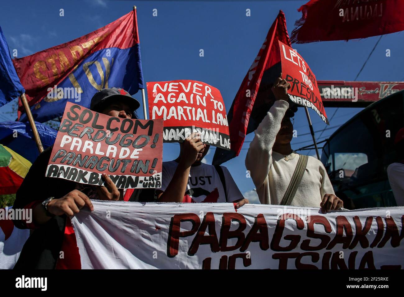 Protesters hold placards as they call for the ouster of President Rodrigo Duterte near the Malacanang Palace in Manila, Philippines. Stock Photo