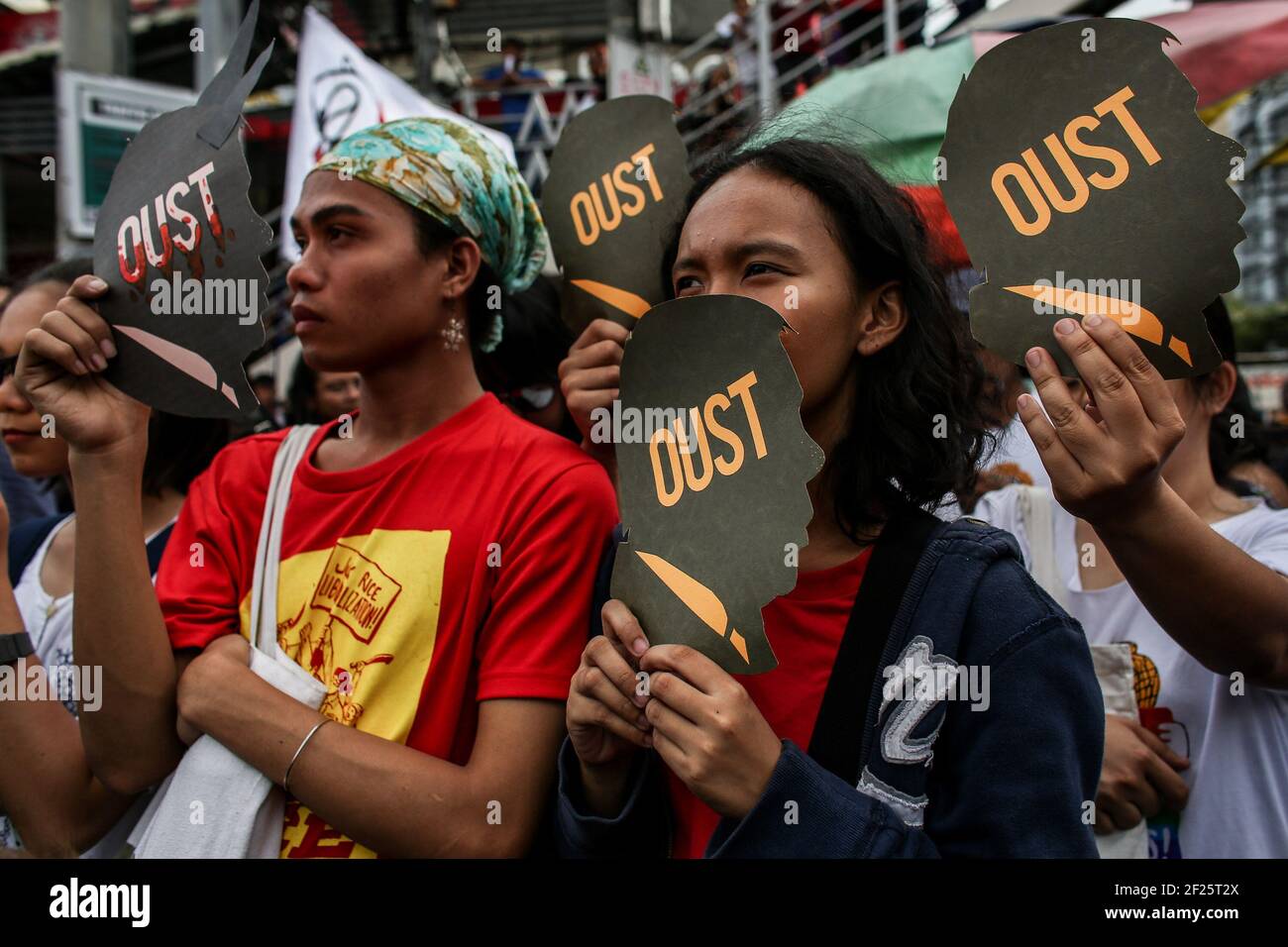 Protesters hold placards as they call for the ouster of President Rodrigo Duterte near the Malacanang Palace in Manila, Philippines. Stock Photo