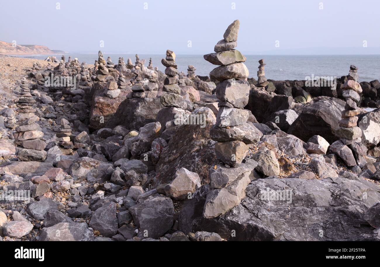 Beach shoreline with hundreds of balancing stones or balanced rocks ...