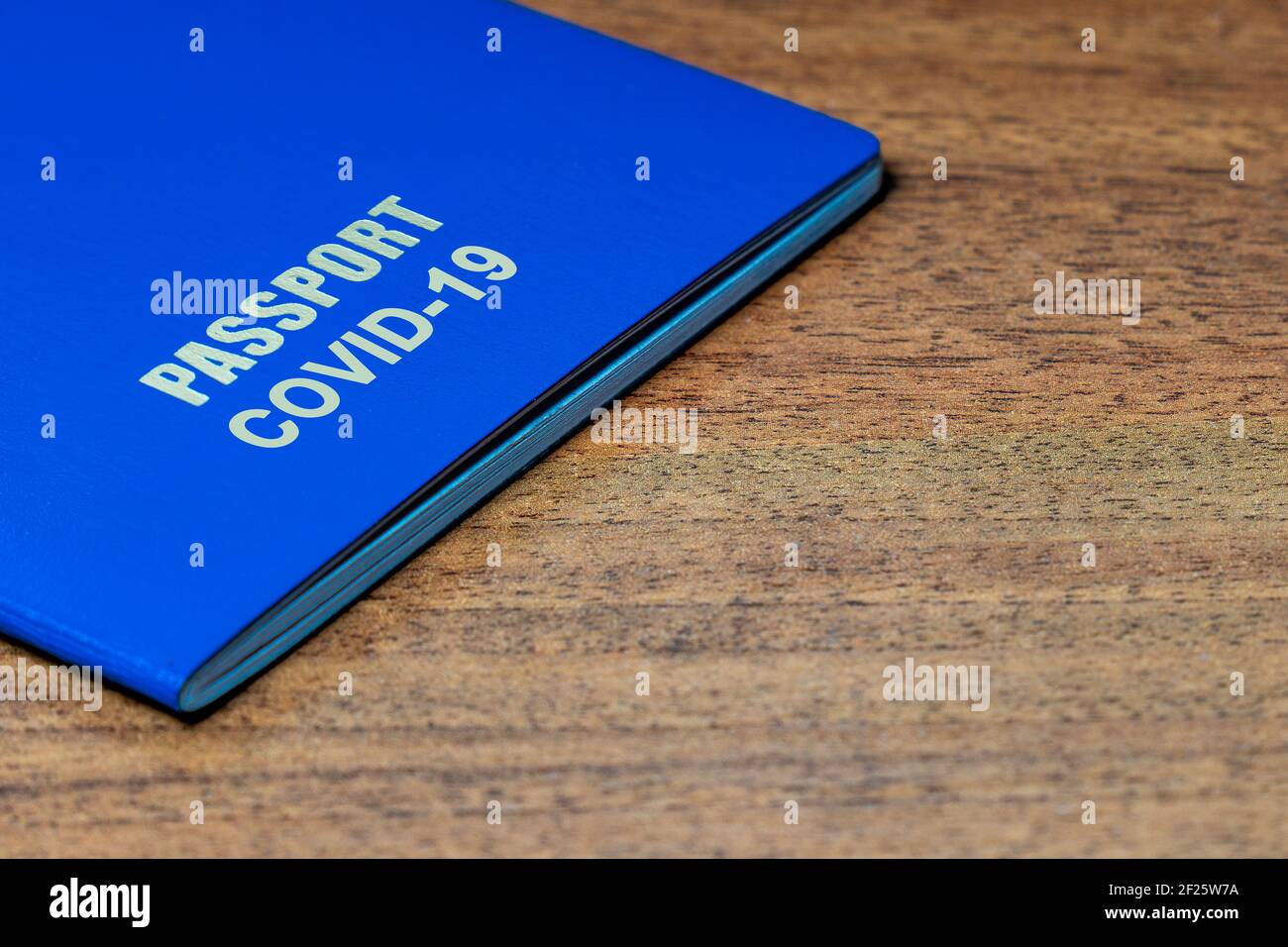 Blue passport with note COVID19 on the desk. Travel and coronavirus