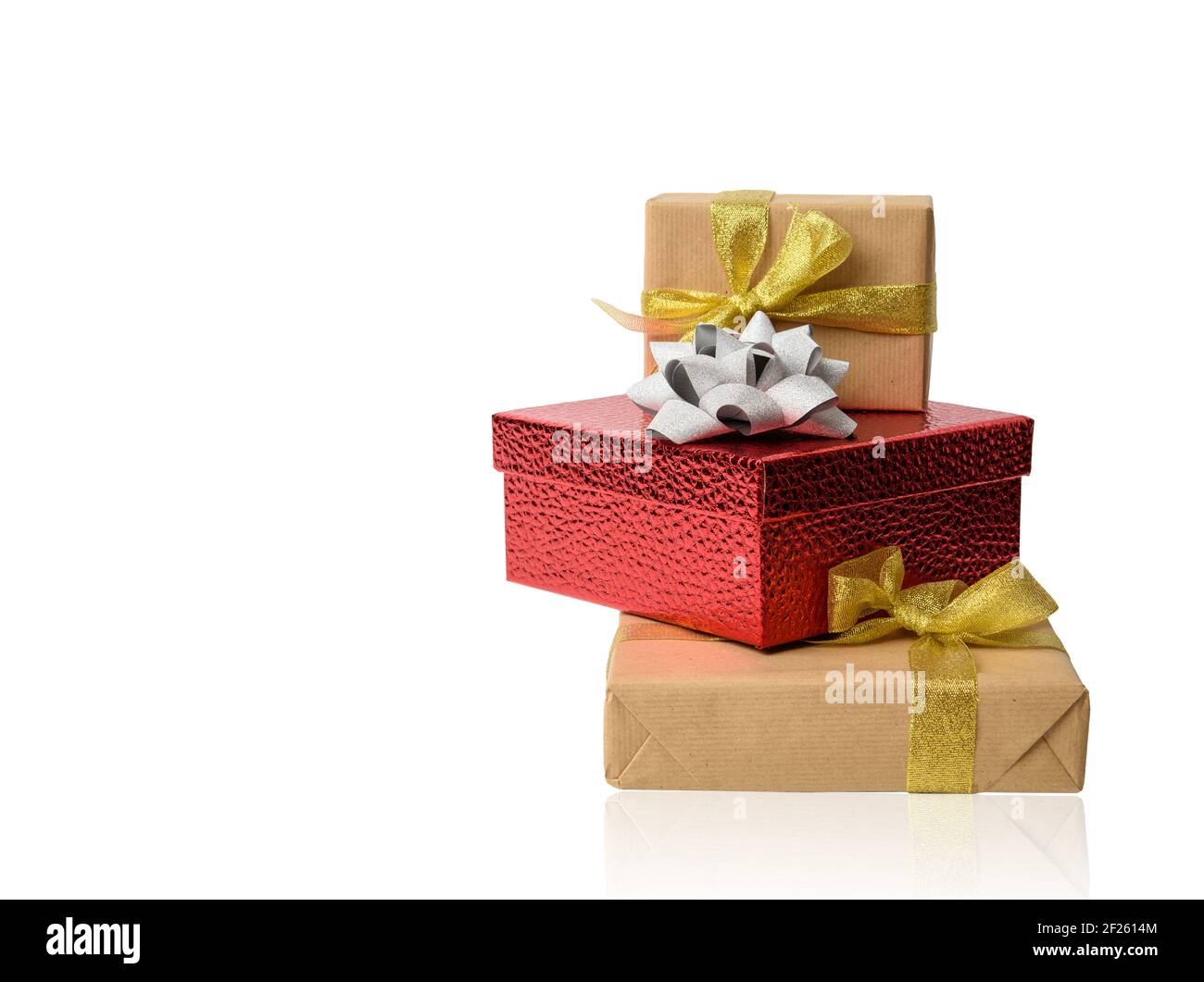 Stack of gifts wrapped in brown kraft paper and tied with silk ribbon ...