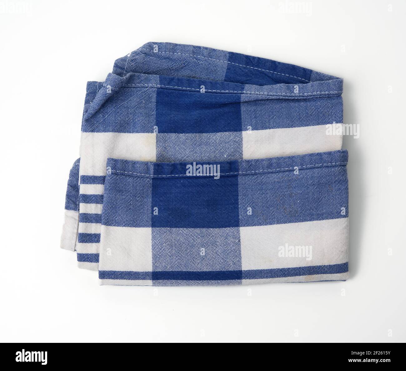 Folded white cotton fabric with blue stripes on white background Stock Photo