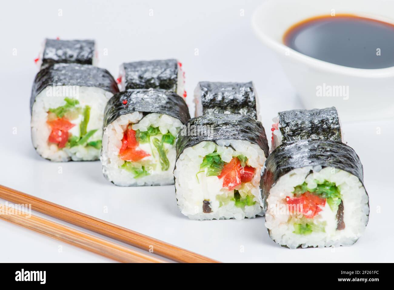 Tasty fresh Sake Avocado Maki sushi with rice, avocado, tobiko and salmon  on light background Stock Photo - Alamy