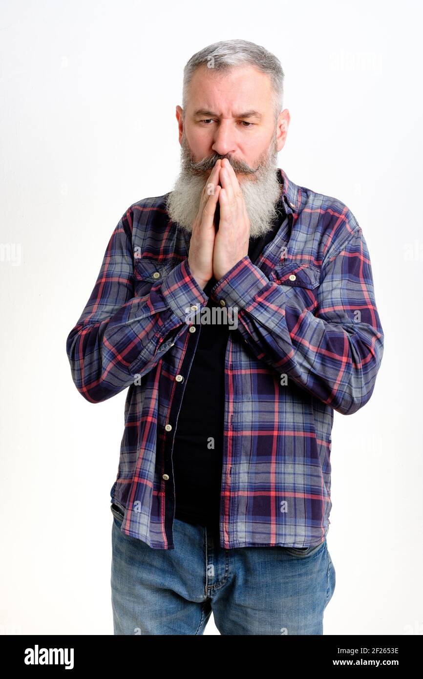 Mature bearded man join hands together begging for forgiveness in trouble, asking for help, isolated on white background Stock Photo