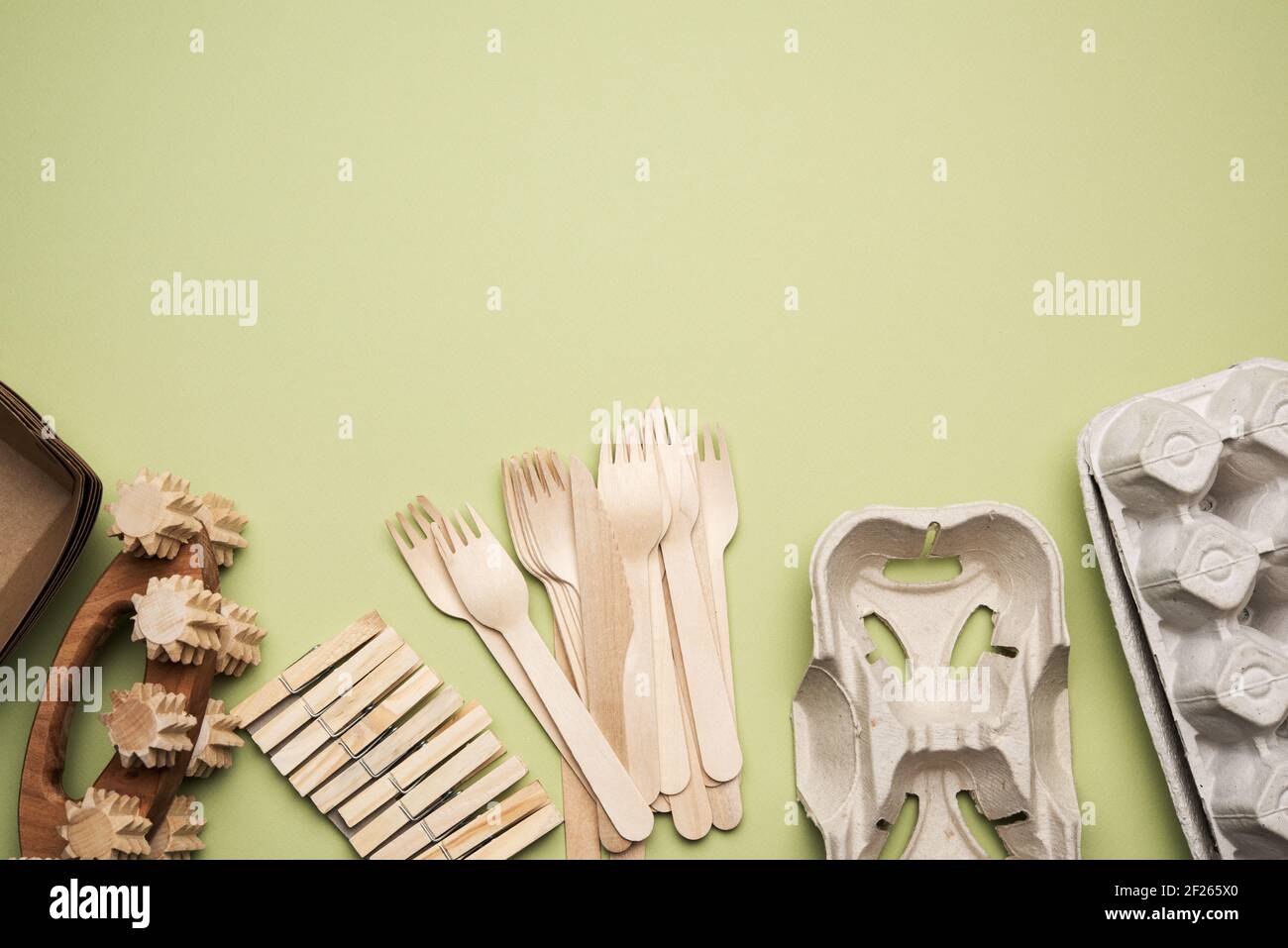 Various household items from recyclable raw materials on a green background Stock Photo