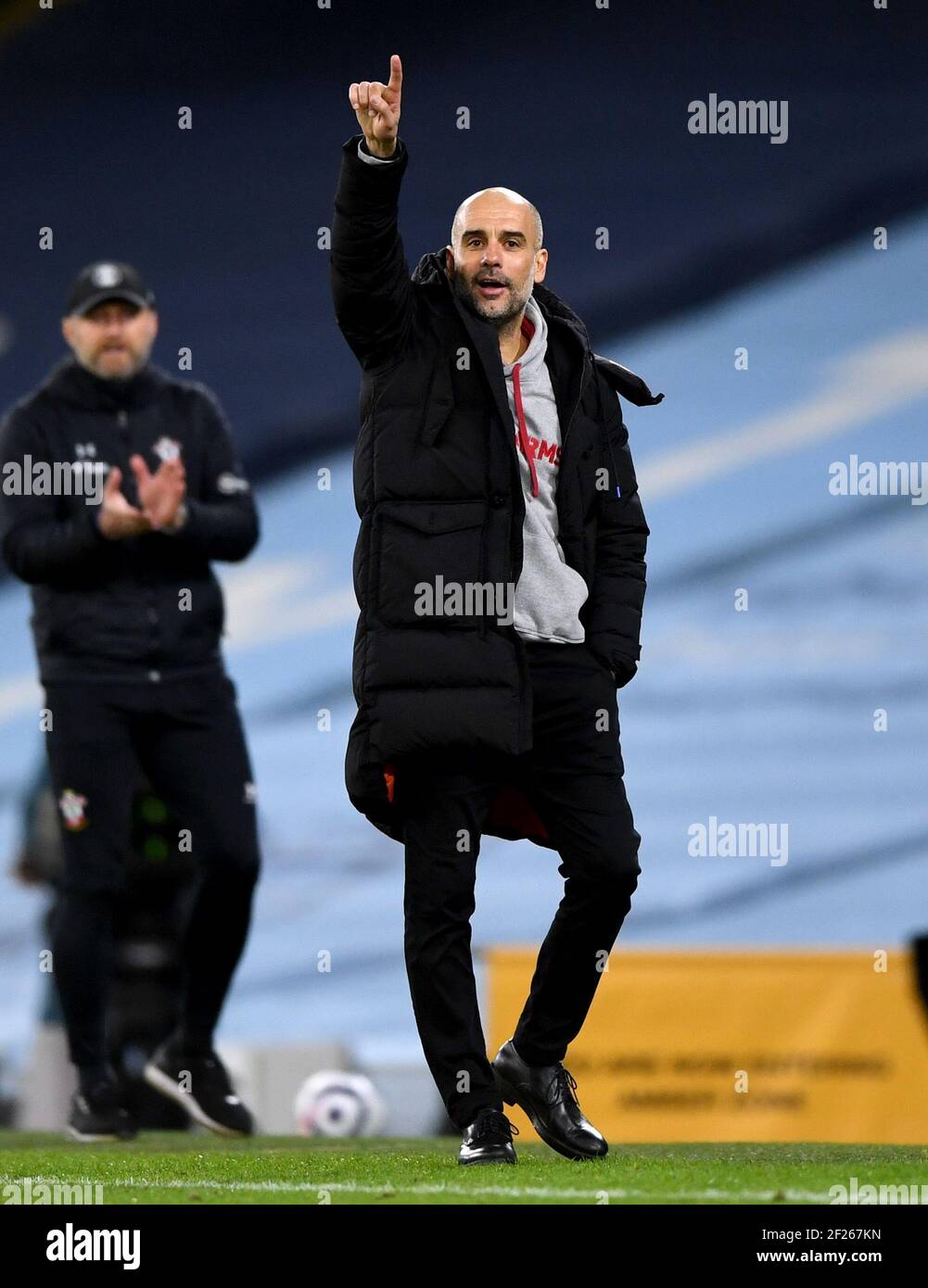 Manchester City manager Pep Guardiola gestures on the touchline during the Premier League match at the Etihad Stadium, Manchester. Picture date: Wednesday March 10, 2021. Stock Photo