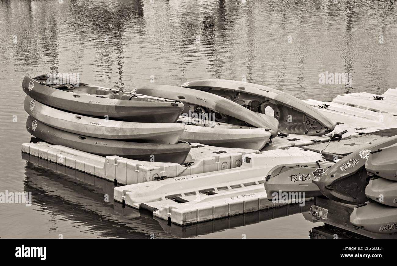 Kayaks stacked on a dock ready for use. Black and white. Stock Photo