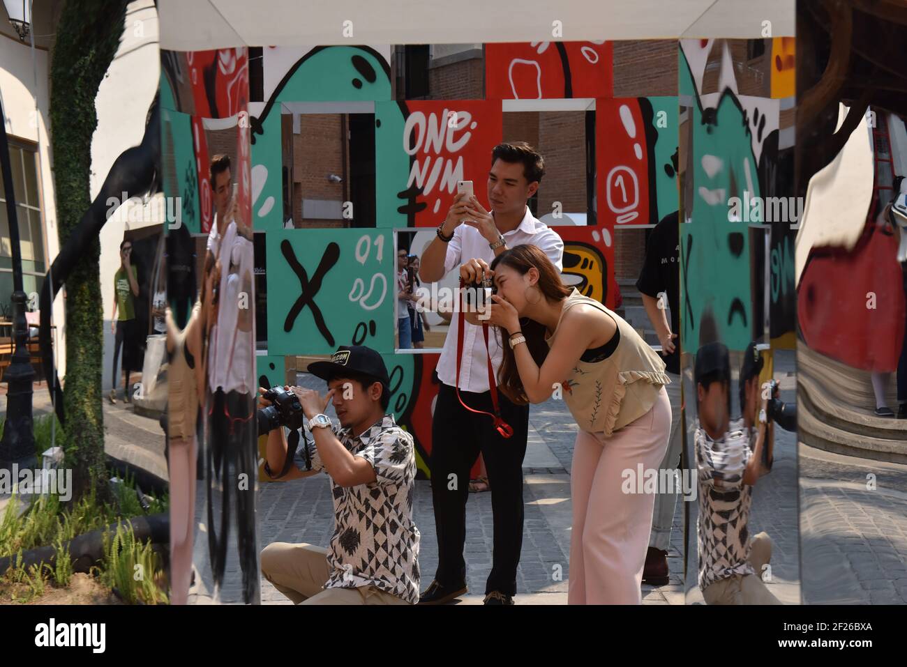 Young thai people taking photographs during exhibition , Chiang Mai, thailand Stock Photo