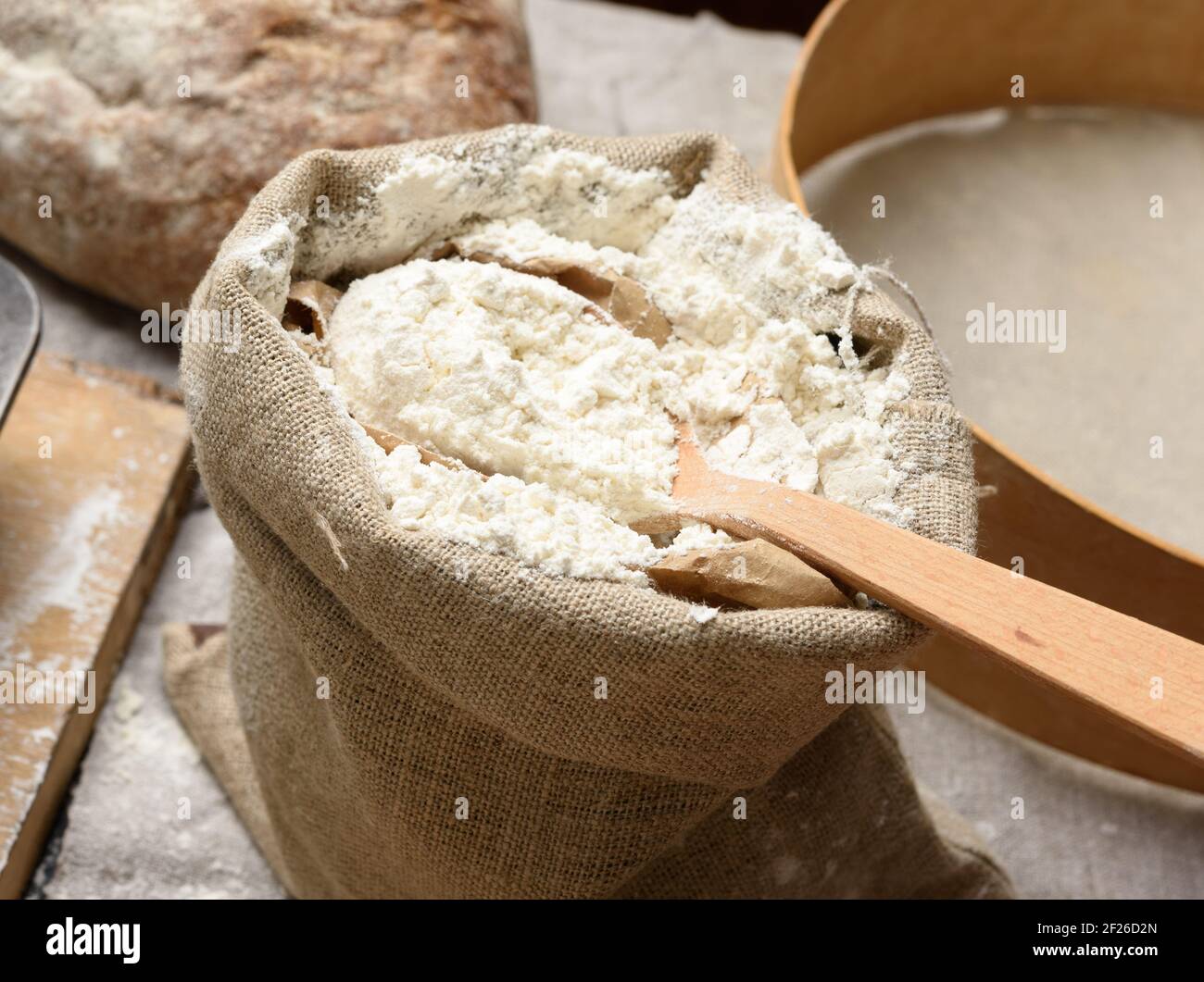 White wheat flour in a small burlap sack Stock Photo
