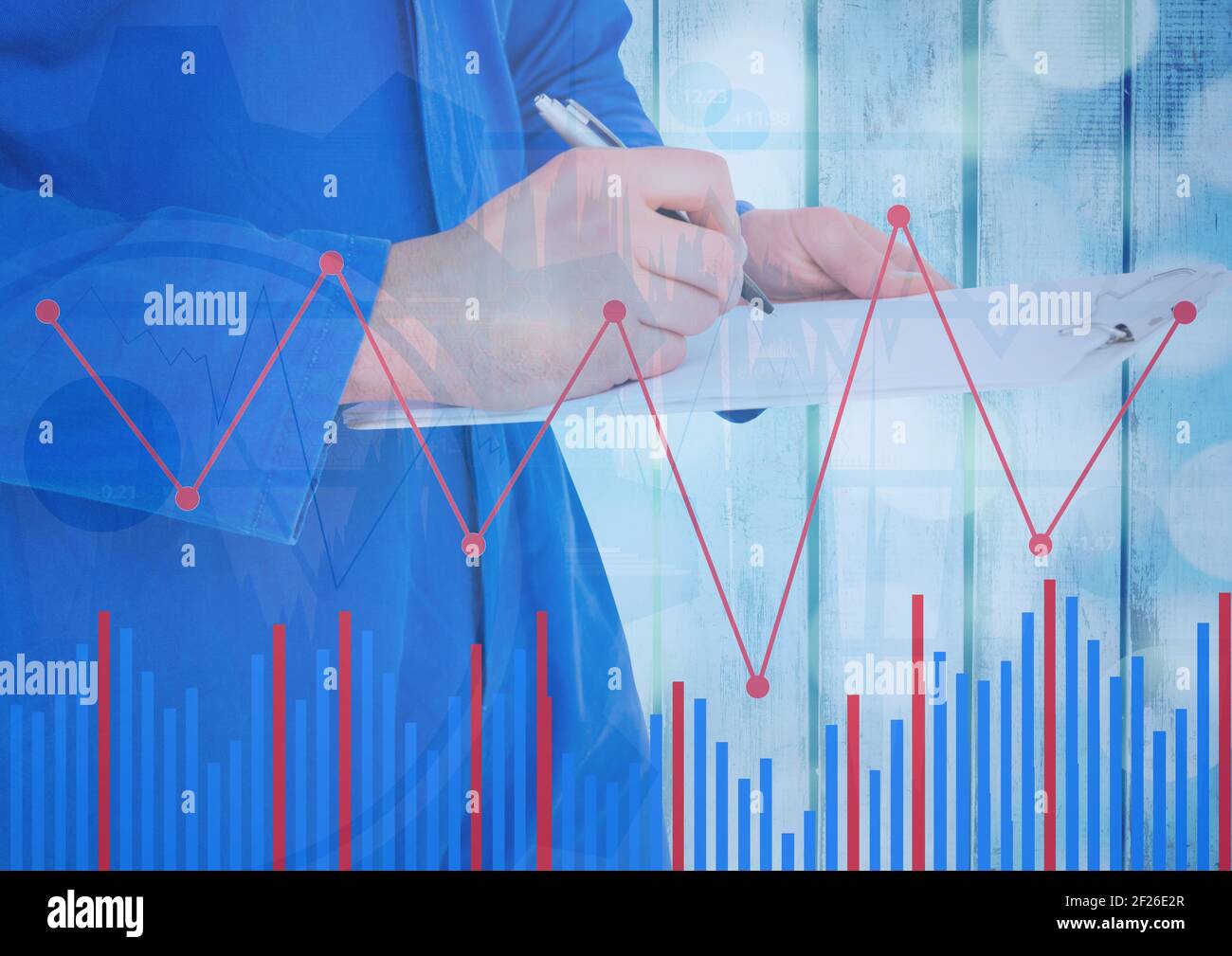 Statistical data processing over mid section of woman taking notes against wooden background Stock Photo
