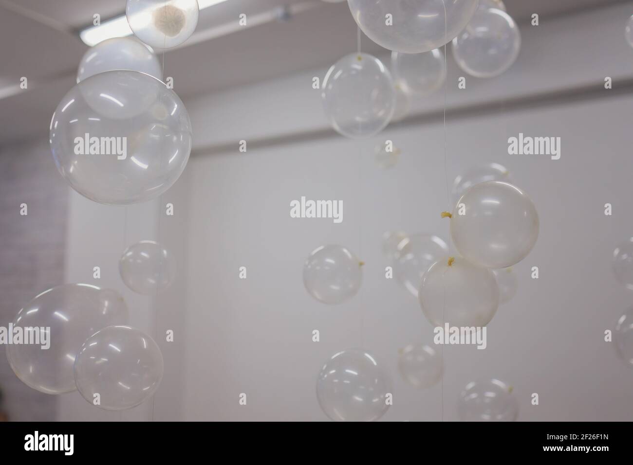 White And Transparent Balloons On Brick Wall Background Stock Photo