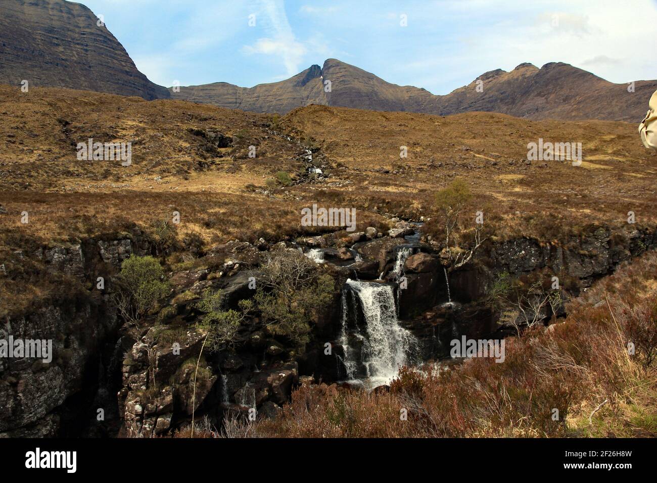 Waterfall cascades down the side of the Torridon mountain range on the west coast of Scotland Stock Photo