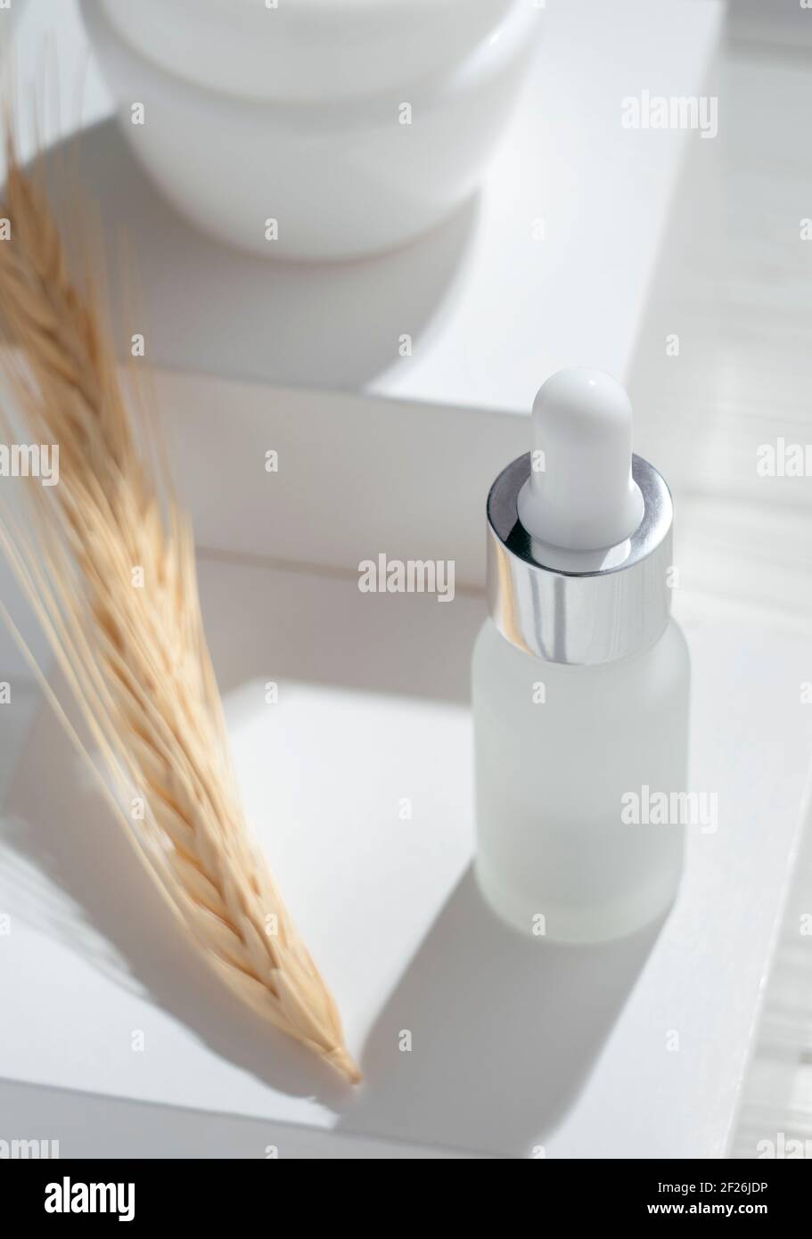 Top view of Pipet bottle and cream container on white boxes Stock Photo
