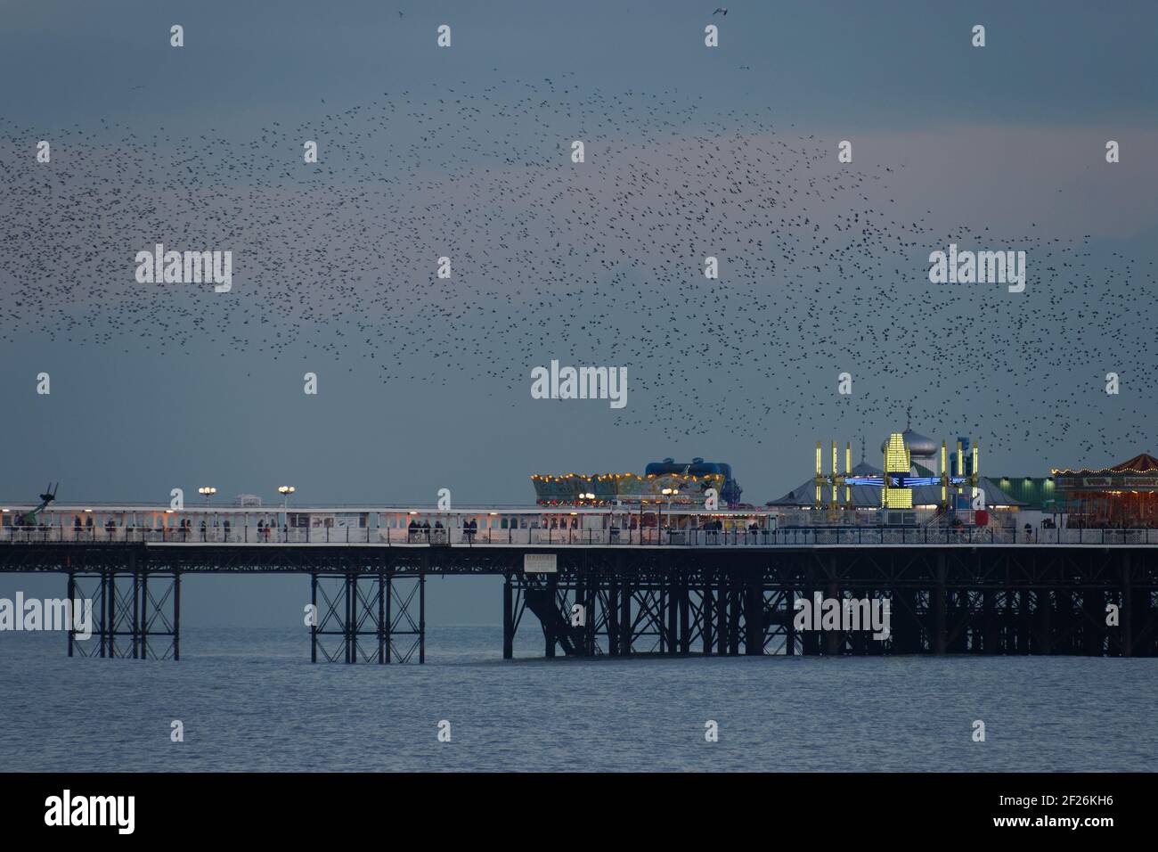 BRIGHTON, EAST SUSSEX/UK - JANUARY 26 : Starlings over the Pier in Brighton East Sussex on January 26, 2018 Stock Photo