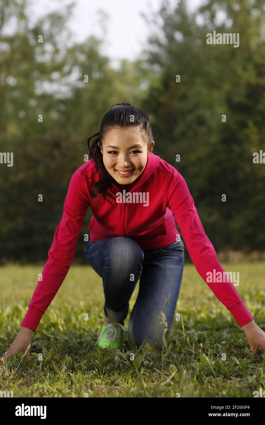 Oriental female youth running in the outdoors Stock Photo
