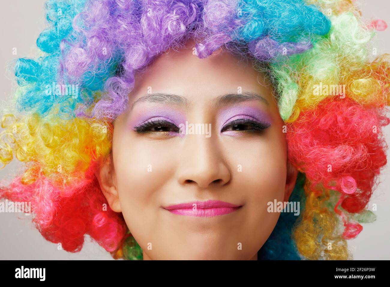 Wearing colored wig Oriental young lady Stock Photo