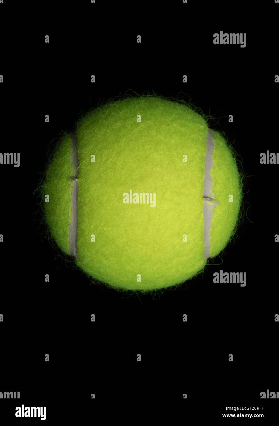 Tennis ball against a black background Stock Photo - Alamy