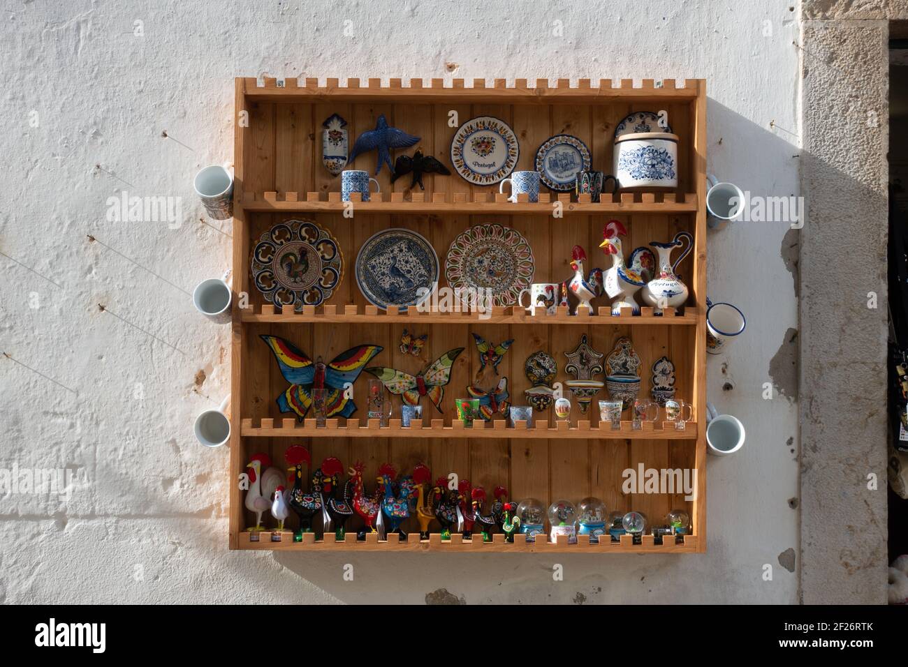 Wood rack with souvenirs of Obidos traditional antique village in