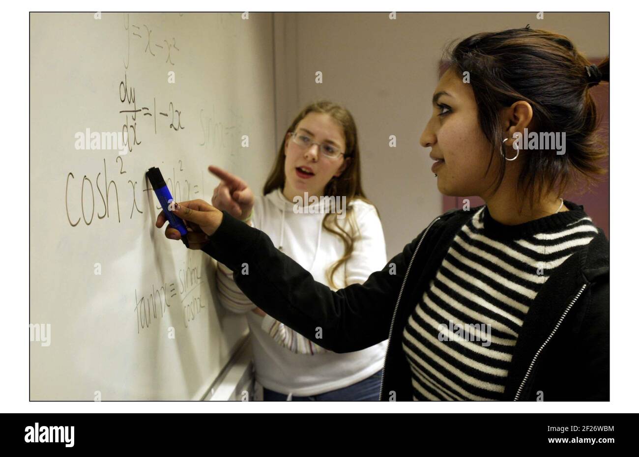 Tiphaine Shah 18 (rt) enjoys Maths and Marsha Vinogradova 16 (lt) who dosn't, 6th formers at Copthall School in Mill Hill, London.pic David Sandison 24/2/2004 Stock Photo