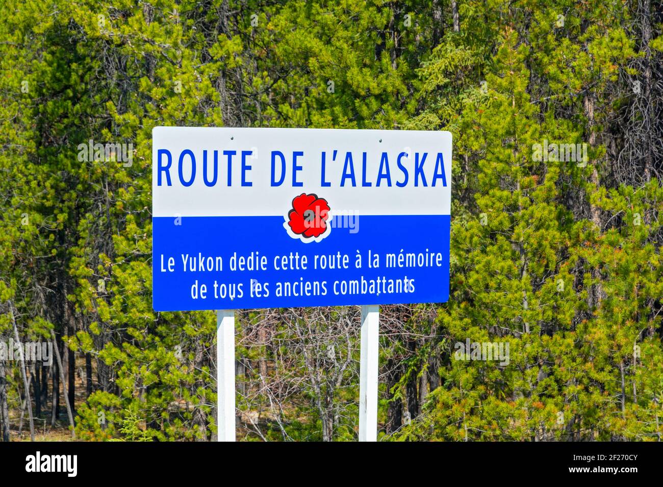 Canada, Yukon, Alaska Highway, sign in French dedicating it to veterans Stock Photo