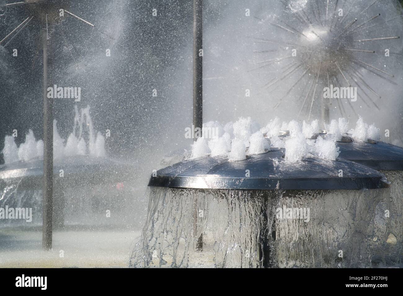 Water games in a fountain. Waterspout fountain with mist, made of stainless steelstainless steel,  mushroom-shaped,  water jet, bubbling. Wasserspiele Stock Photo