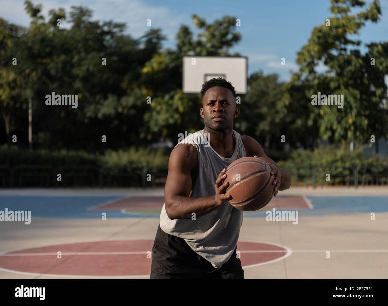 Black basketball player ready to throw ball Stock Photo