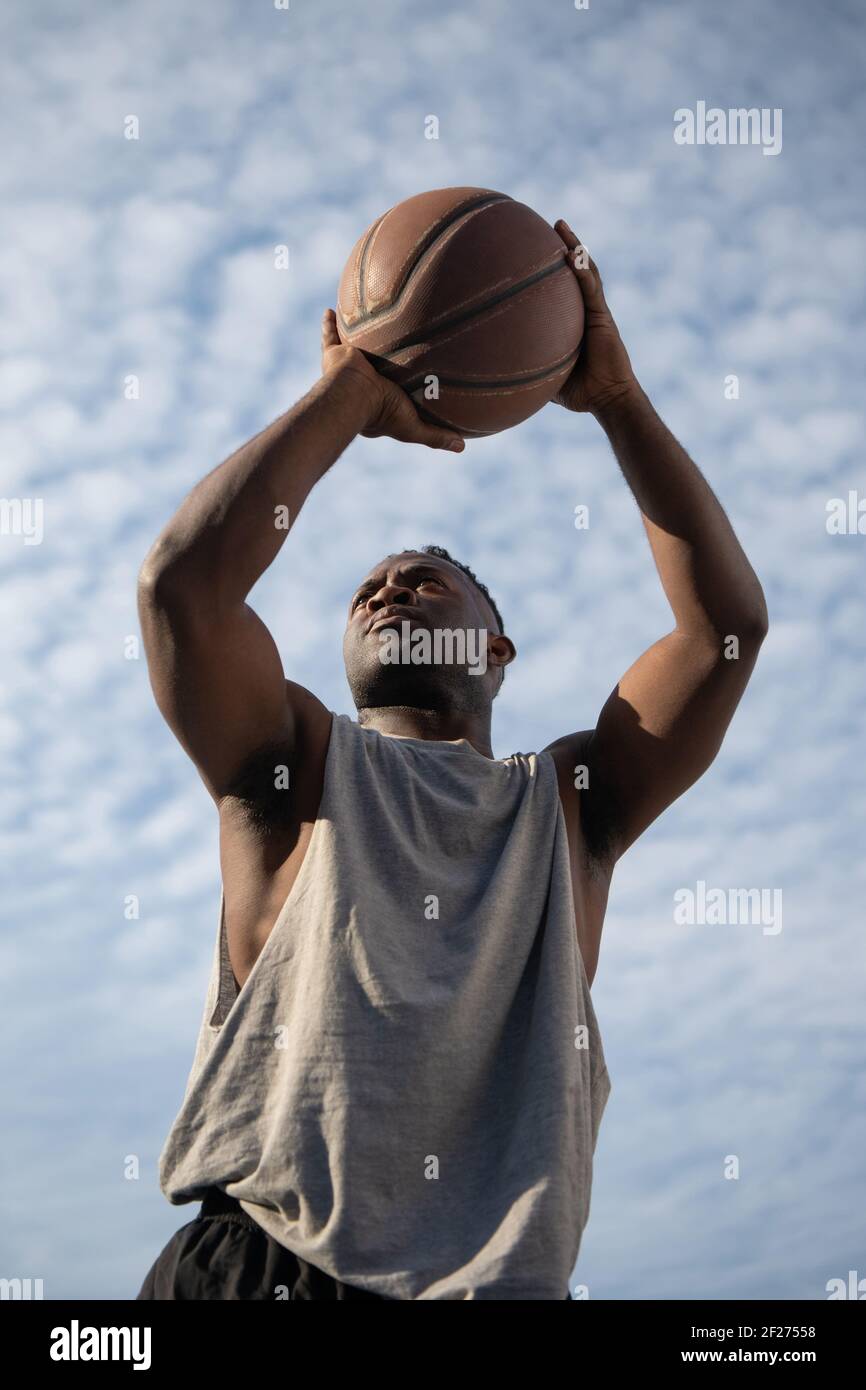 Strong black basketball player throwing ball Stock Photo