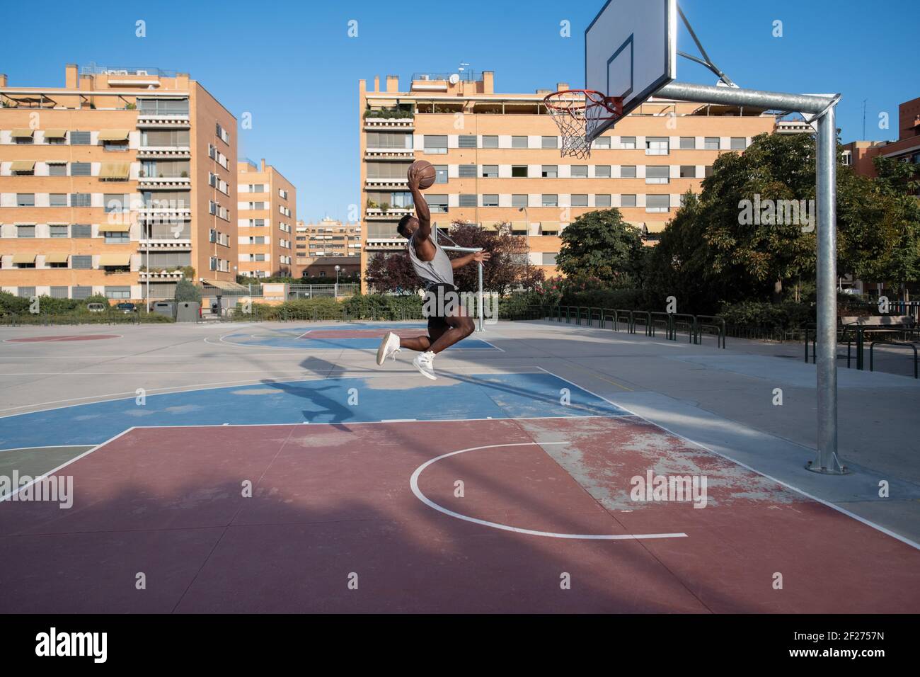 Black man scoring ball during basketball match Stock Photo