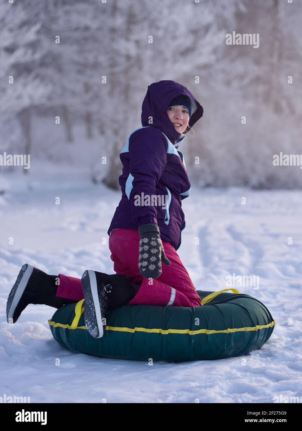 Smiling teen girl enjoying winter activity outdoors Stock Photo