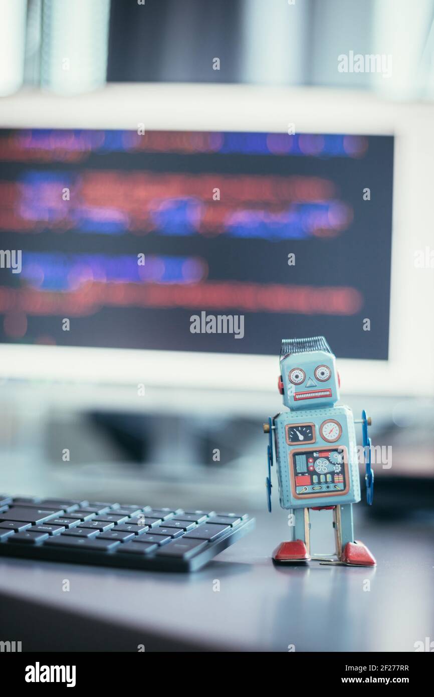 Symbol for a chatbot or social bot and algorithms, program code in the background Stock Photo