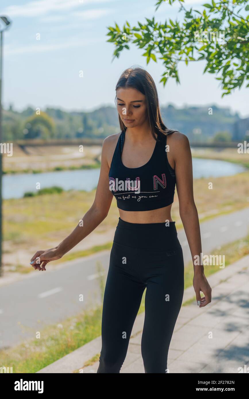 Healthy young woman learning to ride on roller skates and how to keep